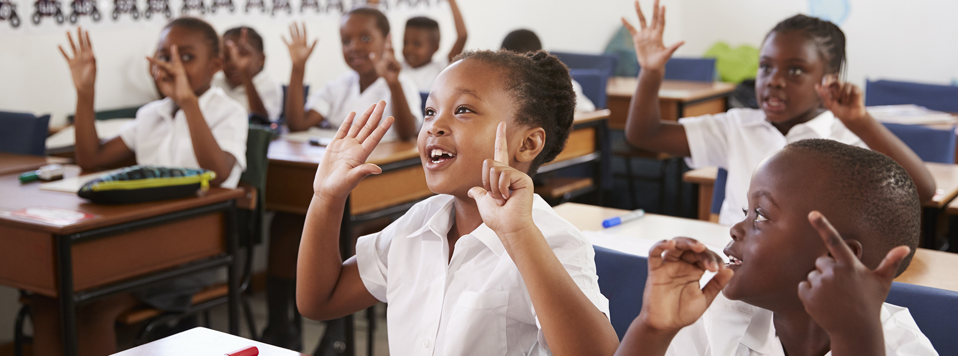 Kids showing hands during a lesson at an elementary school
